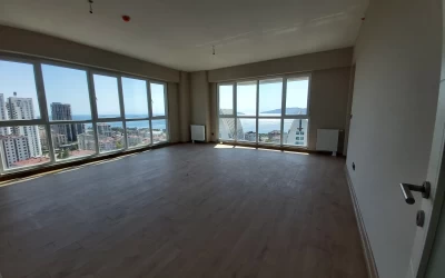interior-view-of-the-empty-and-spacious-living-room-having-quite-large-windows-on-two-separate-walls-with-sea-view