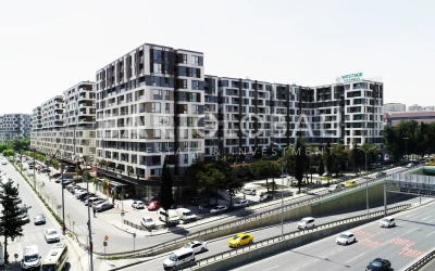 upscale-residential-and-commercial-project-with-plants-and-trees-next-to-main-streets-full-of-cars-in-beylikduzu-district