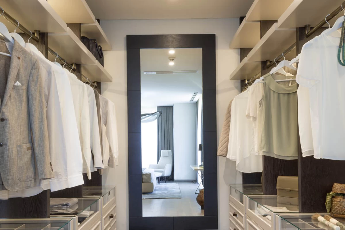 convenient-and-spacious-clothing-room-in-the-bedroom-of-a-luxurious-residence-suits-and-shirts-hung-on-hangers