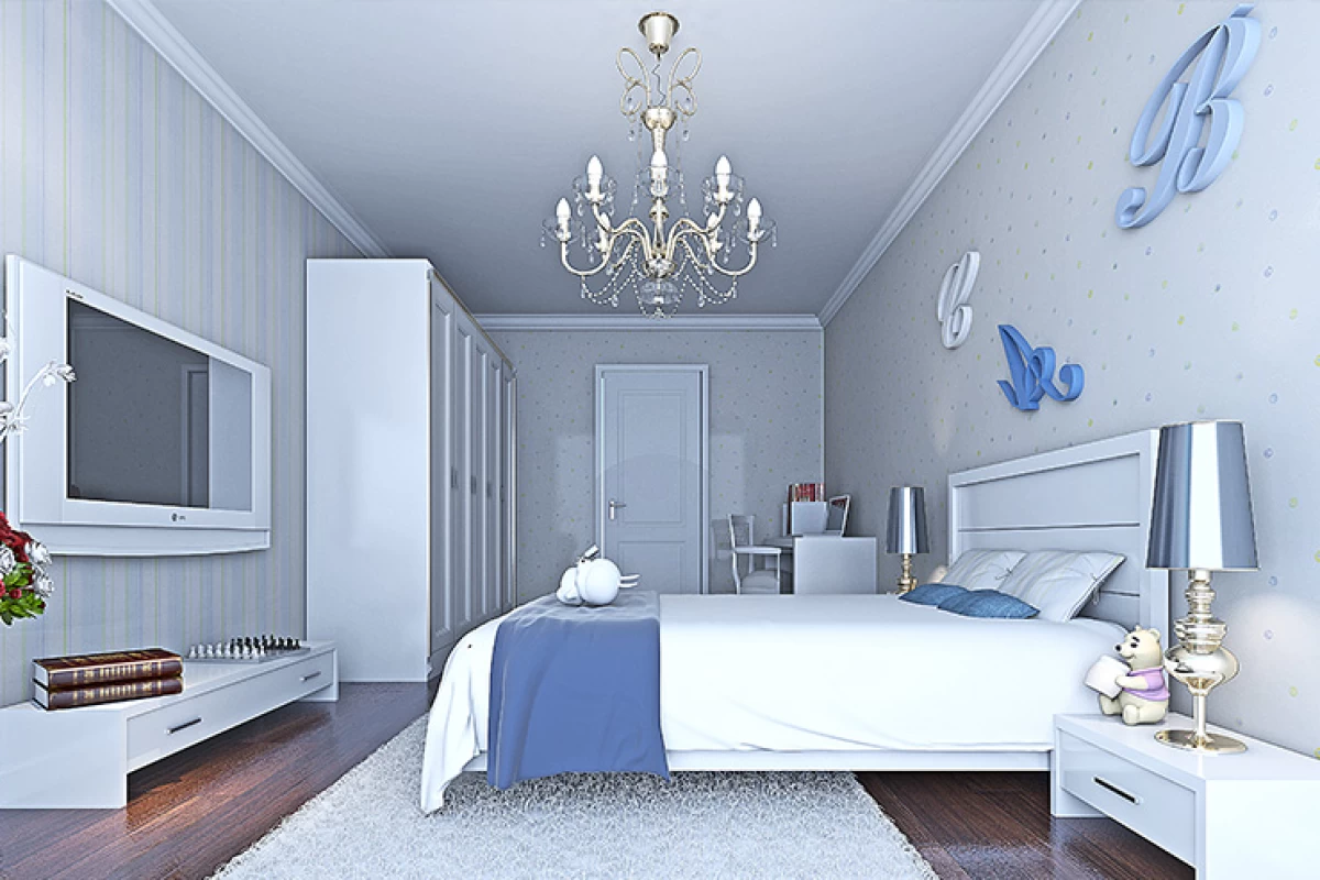 bedroom-with-a-white-double-size-bed-a-blue-cover-on-it-white-closet-and-tv-unit-white-and-blue-patterned-walls-and-a-chandelier