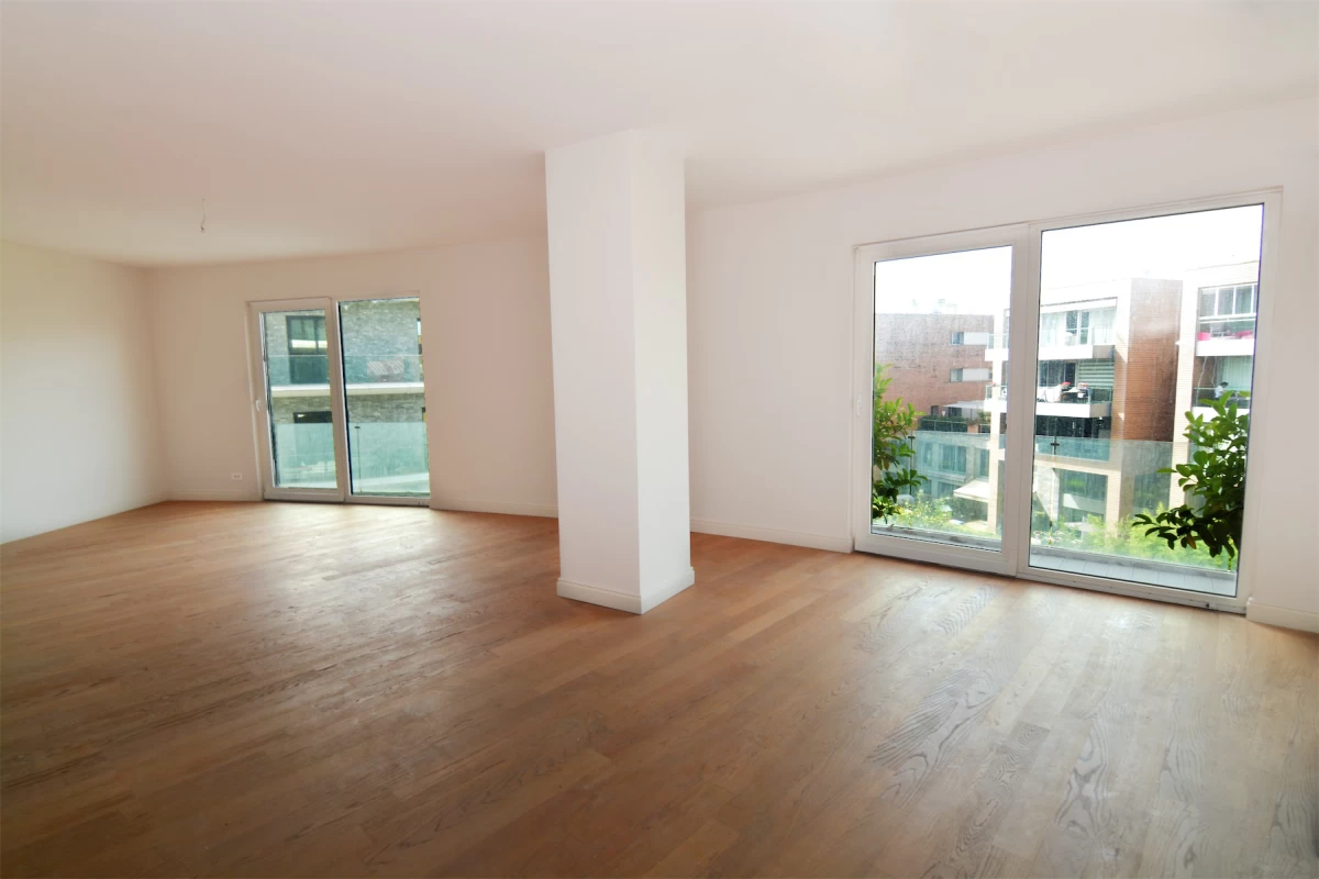 interior-look-of-an-empty-living-room-from-the-project-having-two-seperate-windows-with-the-view-of-other-apartments