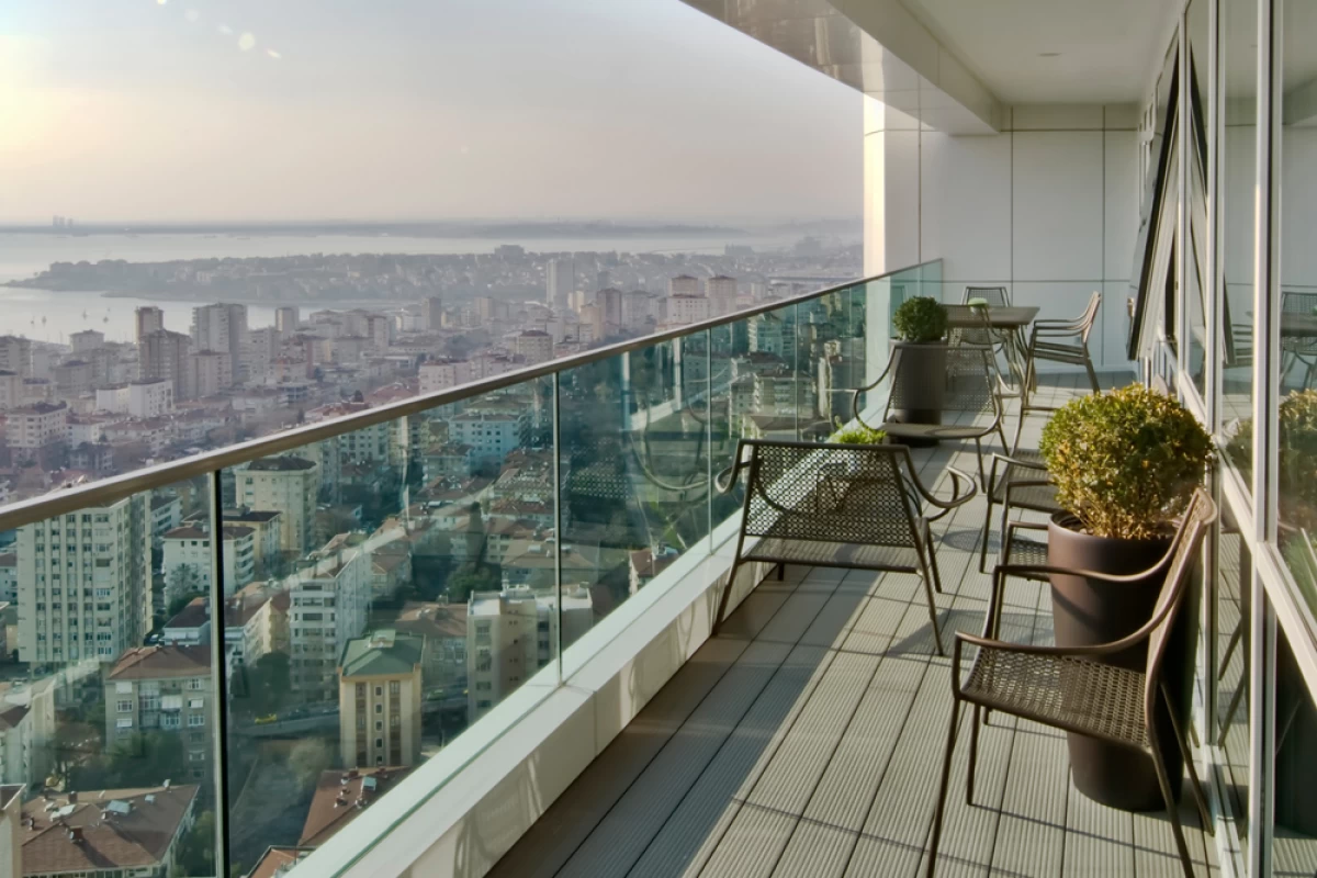 exterior-view-of-the-city-that-is-shot-from-the-balcony-with-black-tables-and-chairs-taking-place-in-the-apartment
