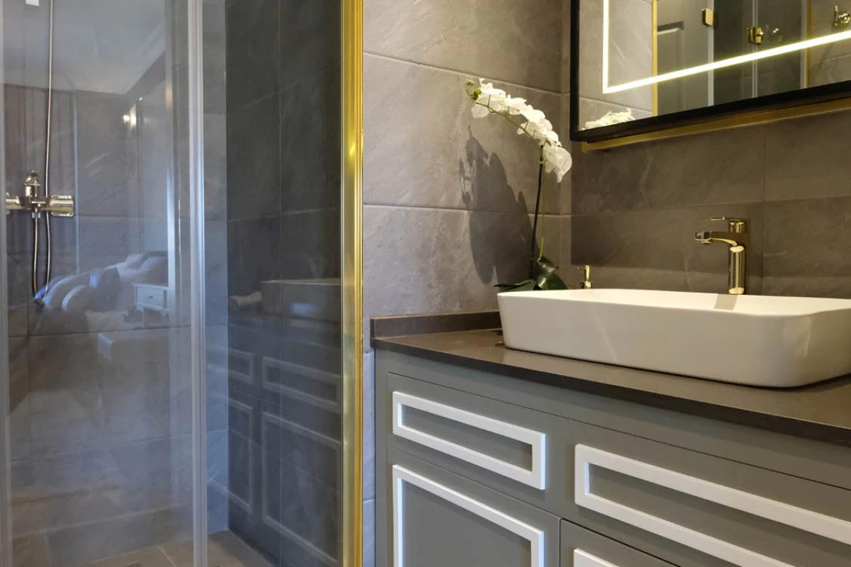 a-modern-design-bathroom-with-bath-cabinet-shower-cabin-grey-marble-walls-and-led-mirror