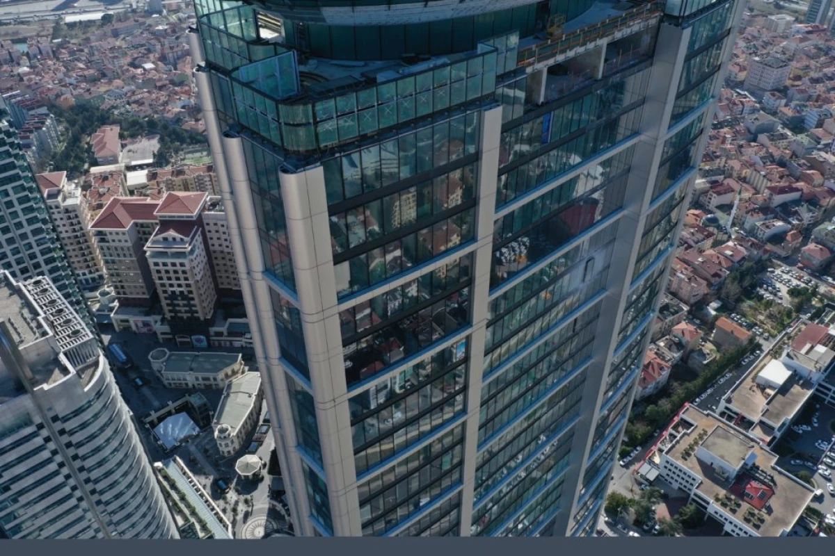 high-angle-shot-of-skyscraper-with-floor-to-ceiling-windows-with-one-way-glasses-in-uskudar-and-countless-buildings-above