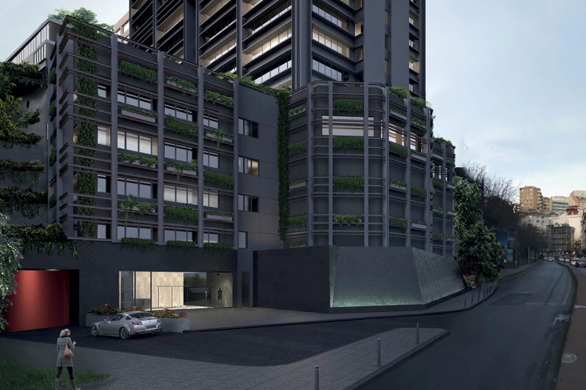 a-black-residential-and-commercial-building-with-car-parking-lot-next-to-street-in-the-daytime