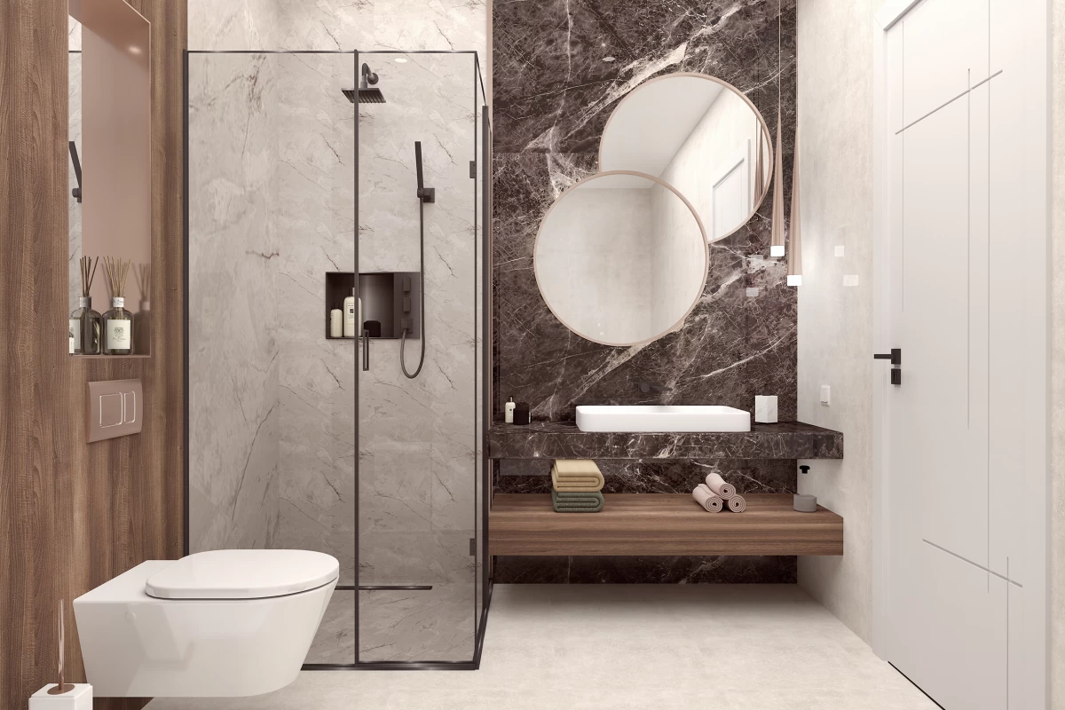 elegant-bathroom-with-brown-and-beige-marble-covers-a-bath-cabinet-towels-under-it-and-round-mirror-above-a-shower-cabinet-and-a-toilet