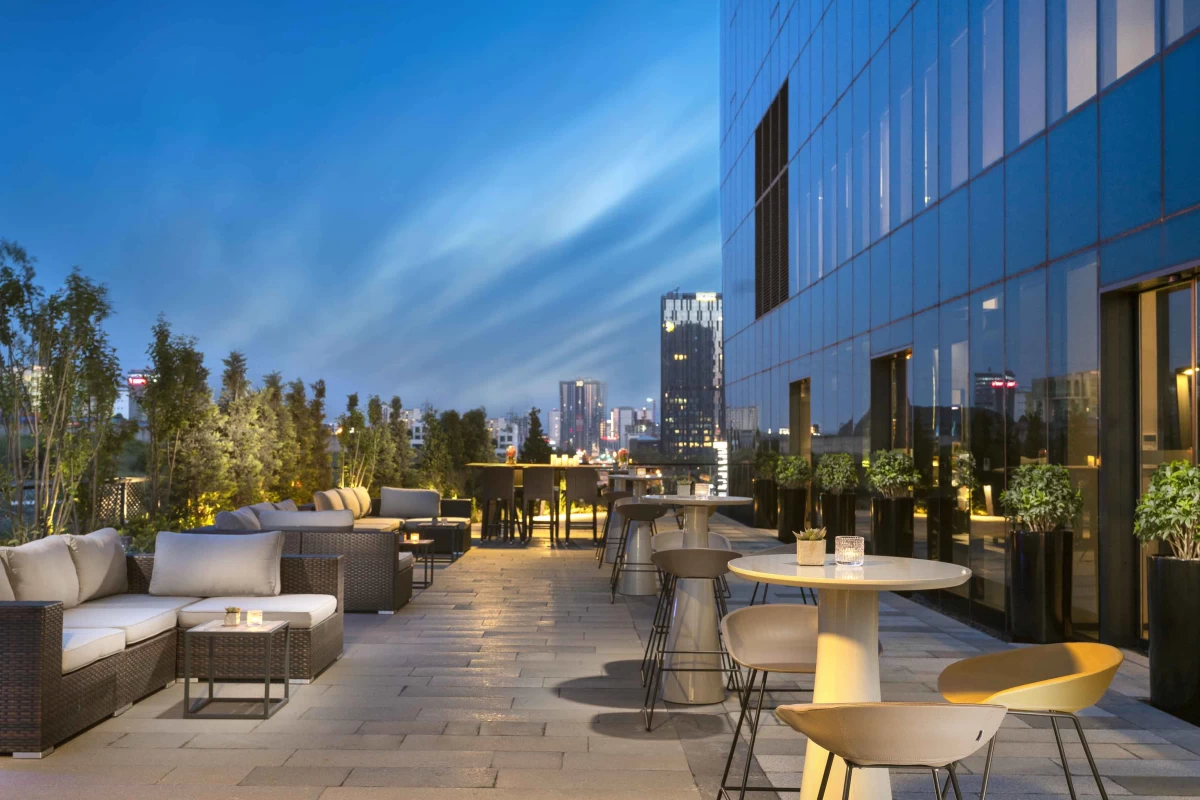 exterior-view-of-the-project-and-its-private-lobby-terrace-part-with-coffee-tables-in-the-evening-time