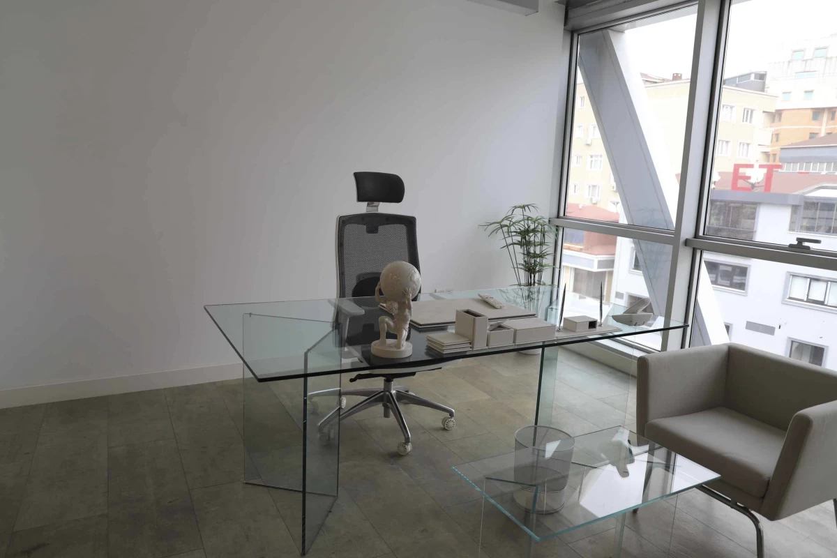 interior-view-of-private-working-room-of-a-manager-including-a-made-of-glass-table-and-beige-armchair