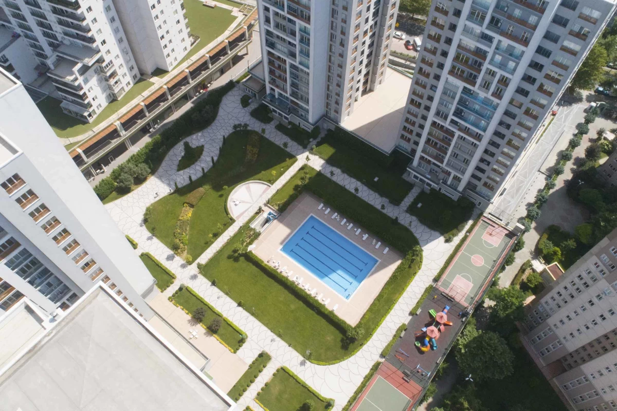 high-angle-shot-of-residences-with-social-amenities-swimming-pool-children-playground-basketball-courts-and-walking-paths