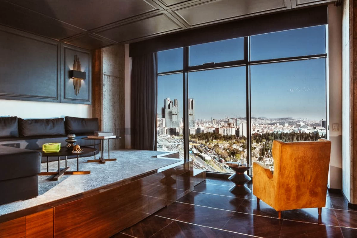 luminous-and-spacious-exclusive-living-room-designed-modernly-with-black-walls-corner-sofa-and-coffee-tables-and-city-view-windows