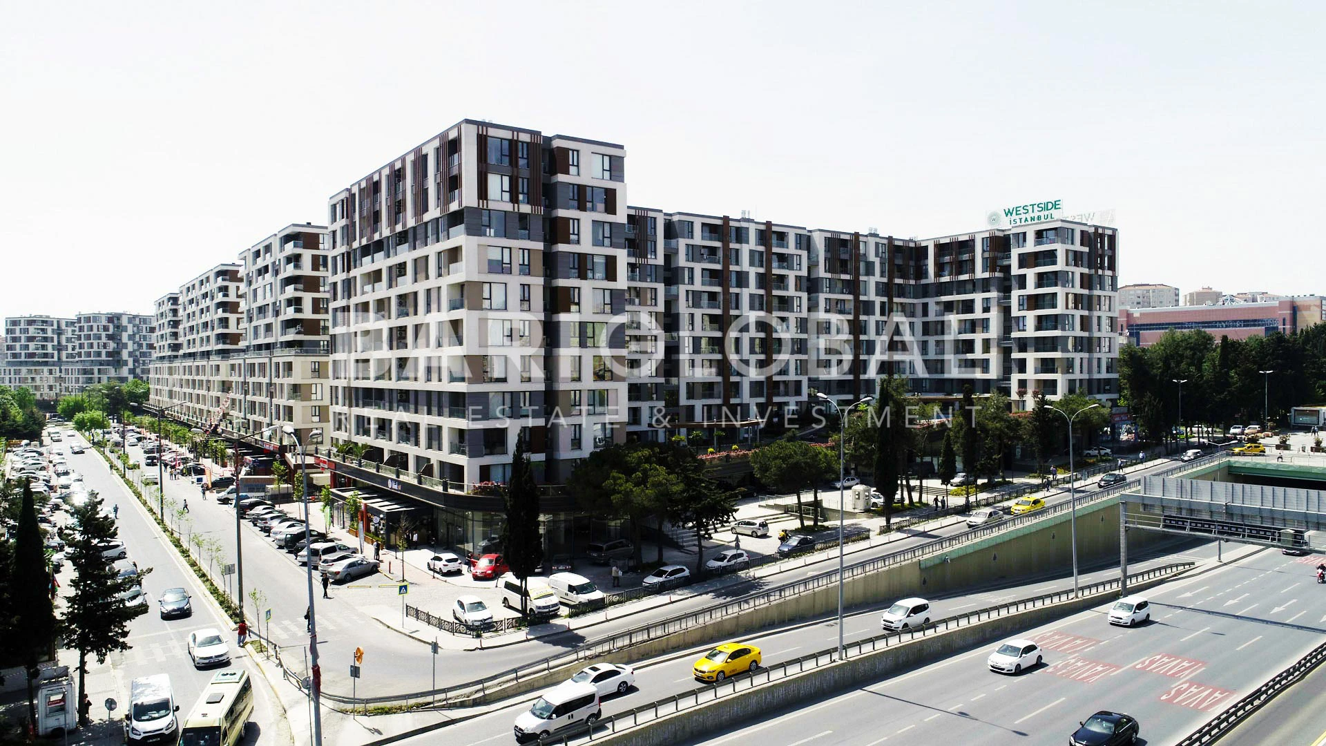 upscale-residential-and-commercial-project-with-plants-and-trees-next-to-main-streets-full-of-cars-in-beylikduzu-district